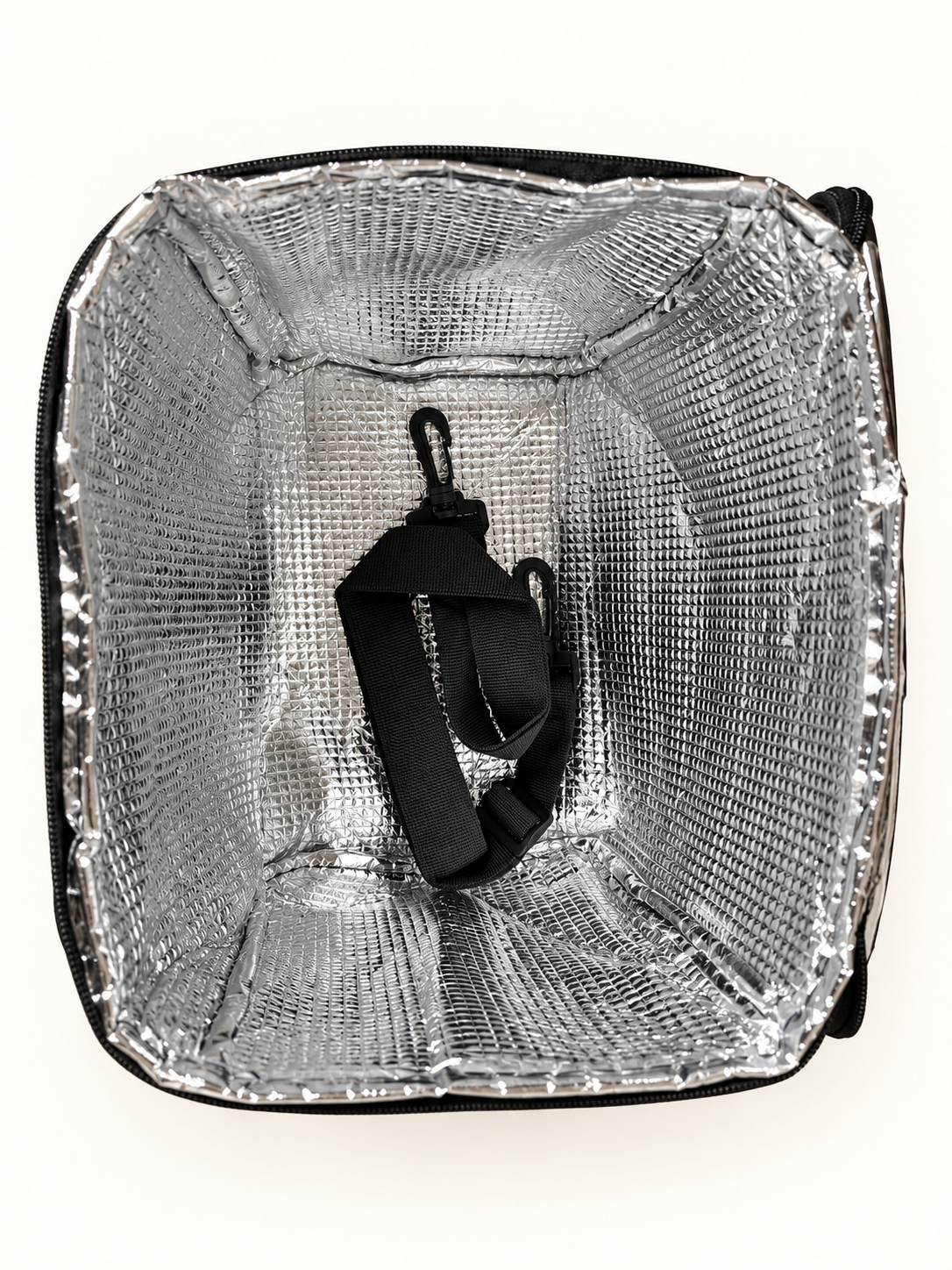 Silver insulated interior and shoulder strap inside cooler bag