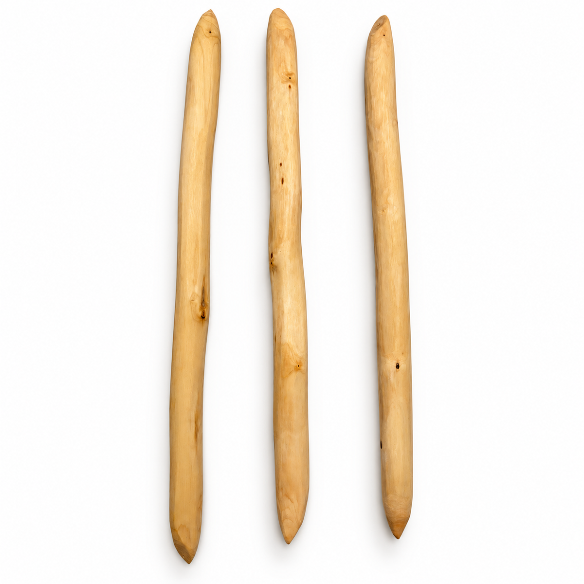 Three handcrafted dogwood throwing sticks by Cade Burgess showing natural variation