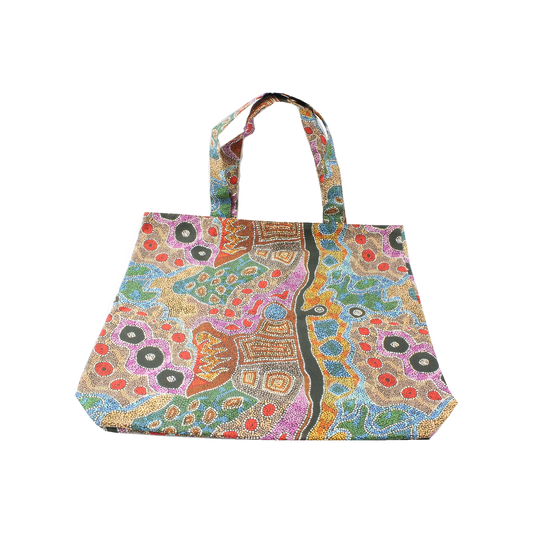 Handmade patterned library bag with two fabric handles on a white background